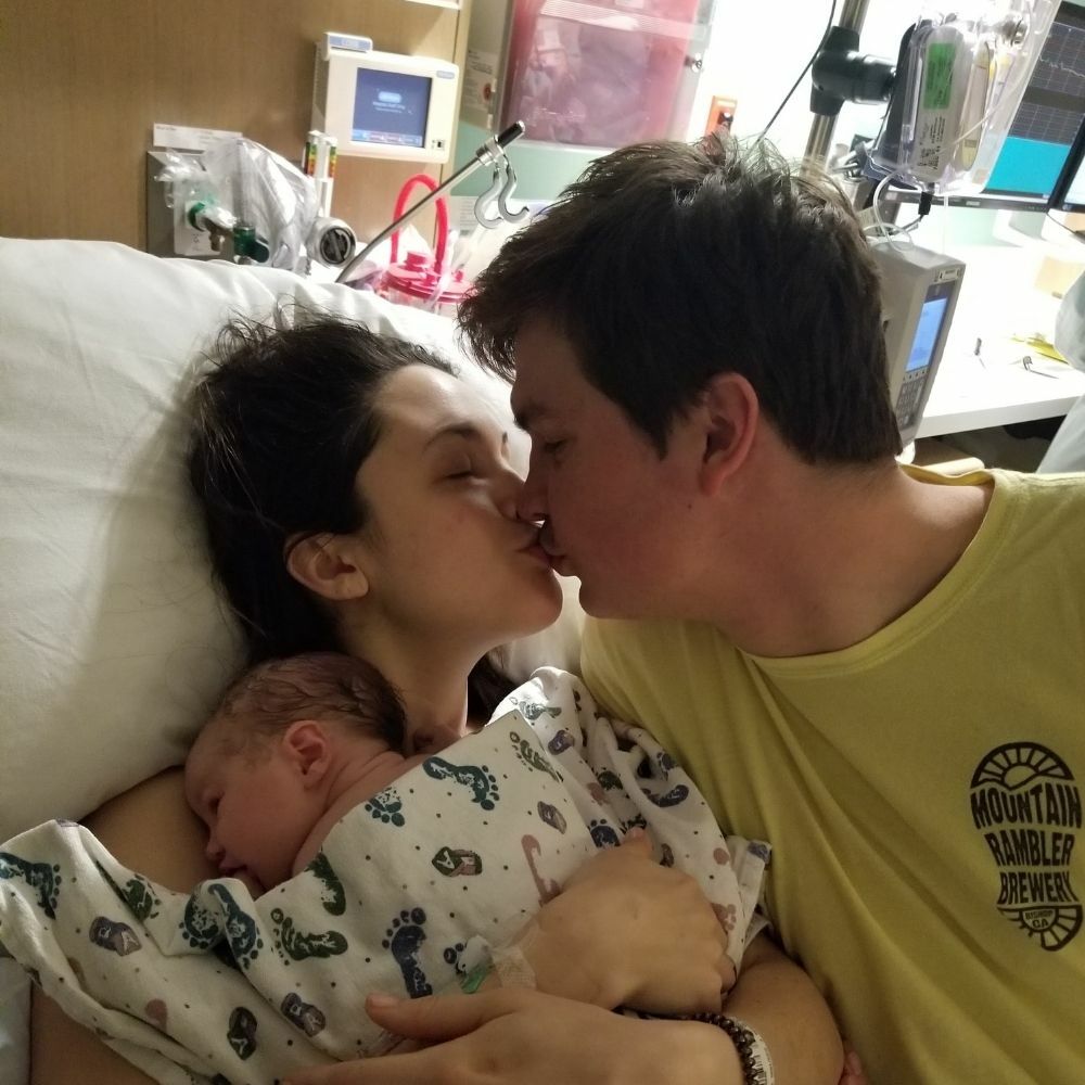 couple kissing after having baby